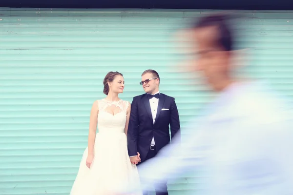 Man blurred passing in front of a bride and groom — Stock Photo, Image