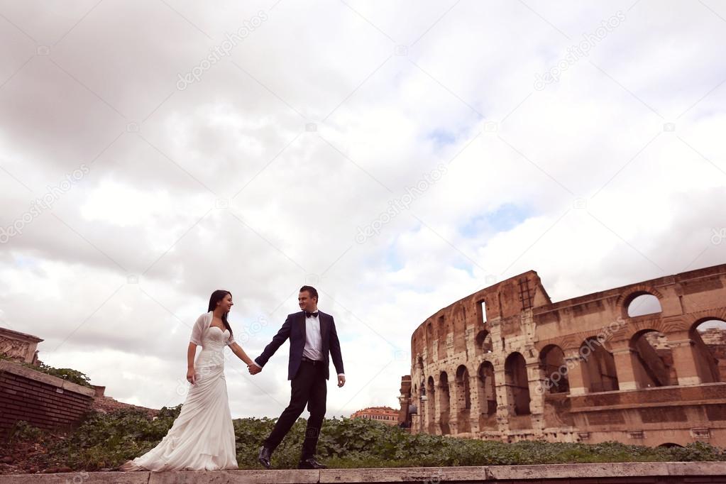 Bride and groom near Colosseum in Rome