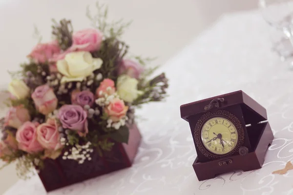 Old clock with bouquet — Stock Photo, Image