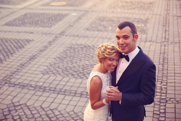 Bride and groom on paved street — Stock Photo, Image