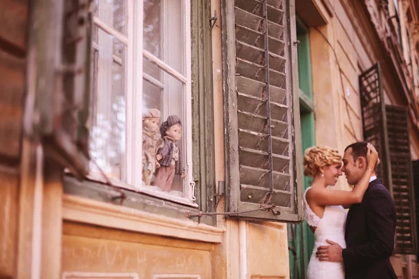 Bride and groom embracing near window — Stock Photo, Image