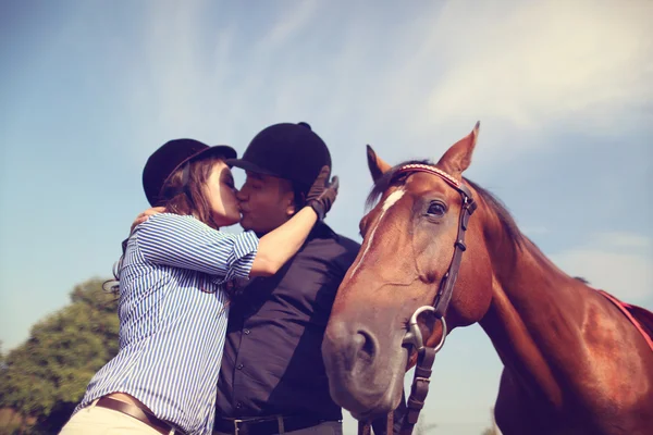 Couple playing with a horse — Stock Photo, Image