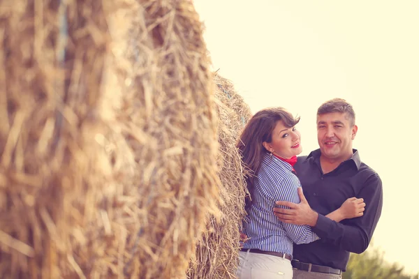 Koppel op een baal hooi — Stockfoto