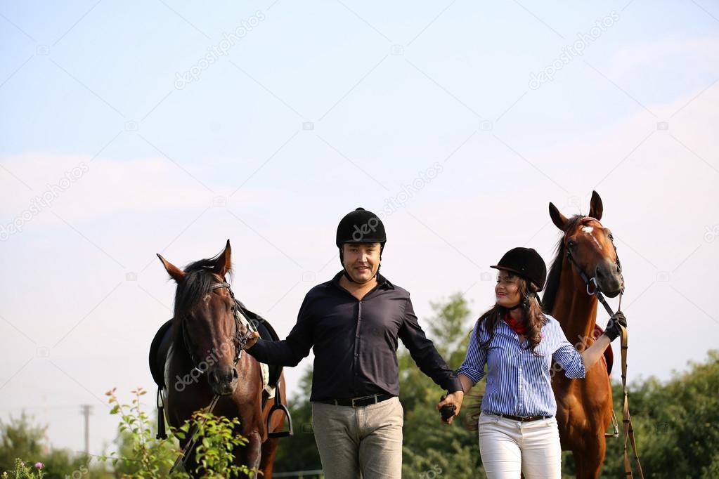 Happy couple with two horses