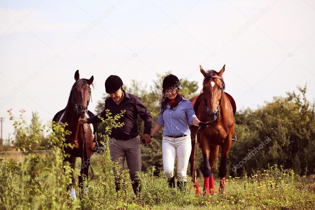 Happy couple with two horses