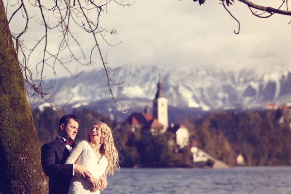 新娘和新郎拥抱湖附近 — 图库照片