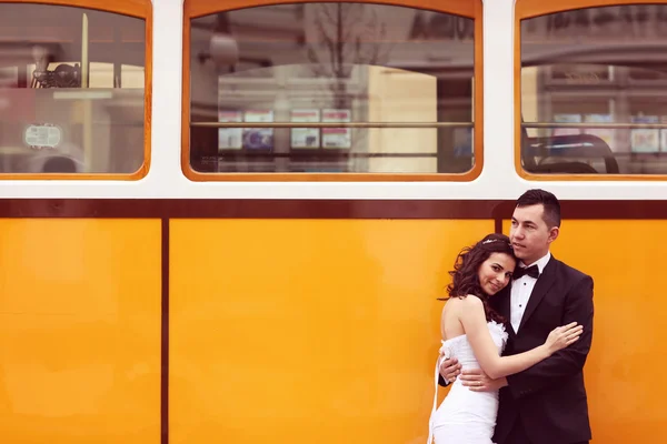 Bride and groom near tram — Stock Photo, Image
