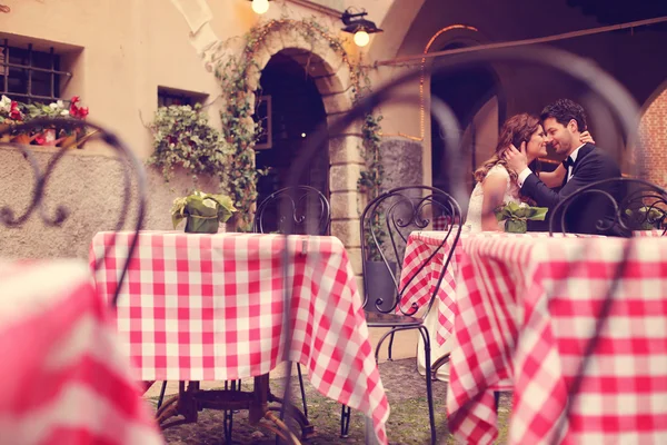 Bride and groom sitting on table — Stock Photo, Image