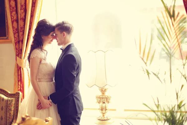 Bride and groom in a hotel room — Stock Photo, Image