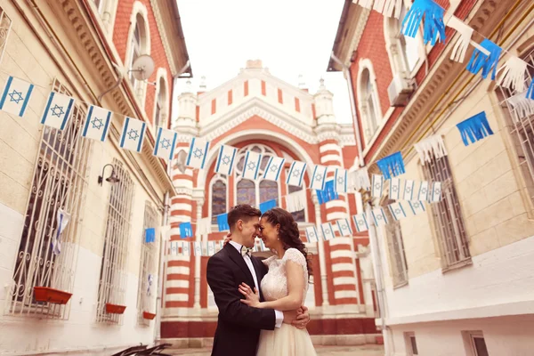 Bride and groom near church — Stock Photo, Image