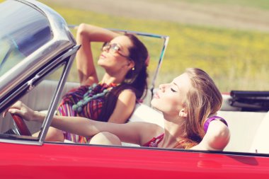Eski model bir retro Araba sürme güneş gözlüğü ile güzel bayanlar