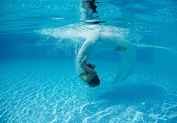 Woman underwater swimming wearing her wedding dress — Stock Photo, Image