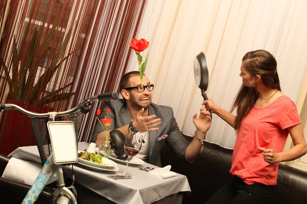 Couple arguing over bike in the dining room — Stock Photo
