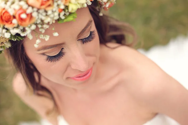 Bela noiva vestindo maquiagem e uma coroa floral — Fotografia de Stock