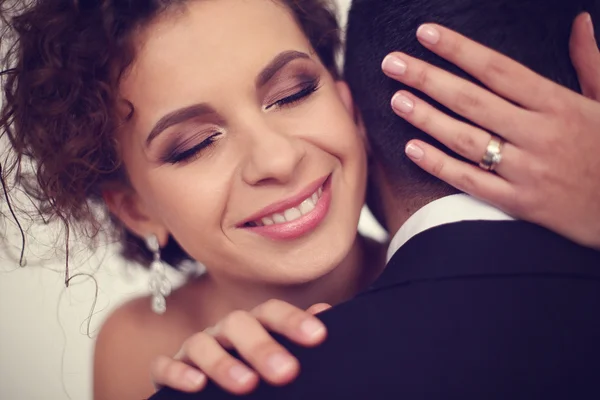 Beautiful bride holding her groom — Stock Photo, Image