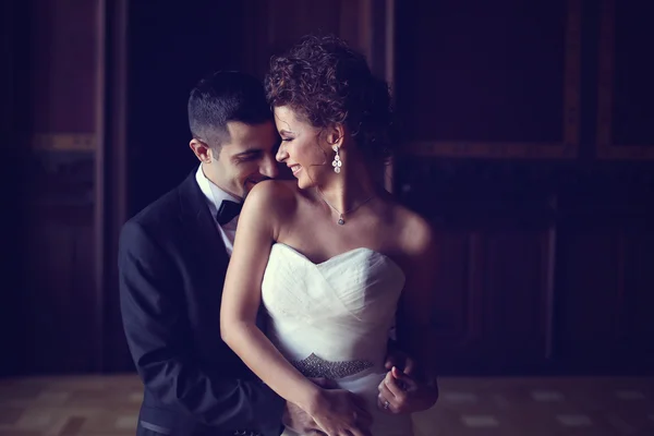 Bride and groom holding each other — Stock Photo, Image