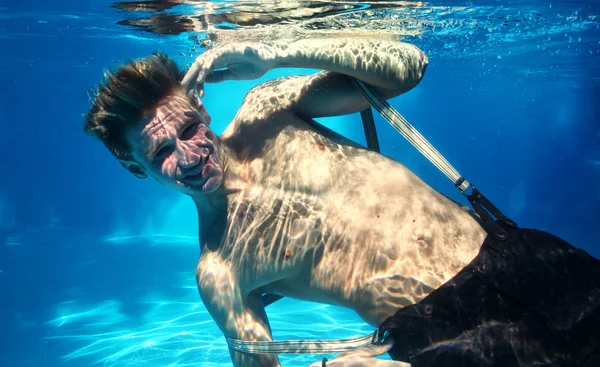 Sexy guy diving in pool underwater — Stock Photo, Image