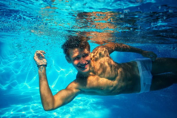 Sexy chico buceo en la piscina bajo el agua — Foto de Stock