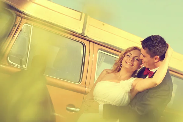 Novia y novio con un autobús retro — Foto de Stock