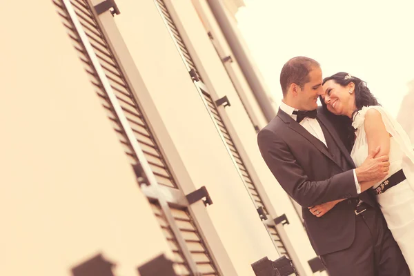 Beautiful bride and groom embracing on wedding day — Stock Photo, Image