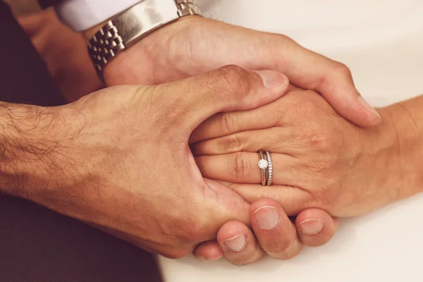 Close-up with bride and groom holding hands — Stock Photo, Image
