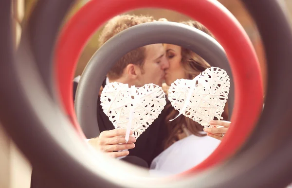 Beautiful bride and groom embracing in the city — Stock Photo, Image