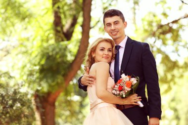 Güzel gelin ve damat parkta kucaklayan