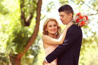 Güzel gelin ve damat parkta kucaklayan