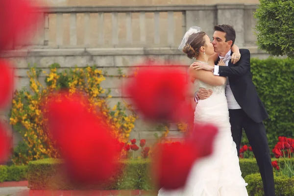 Bride and groom embracing in the park