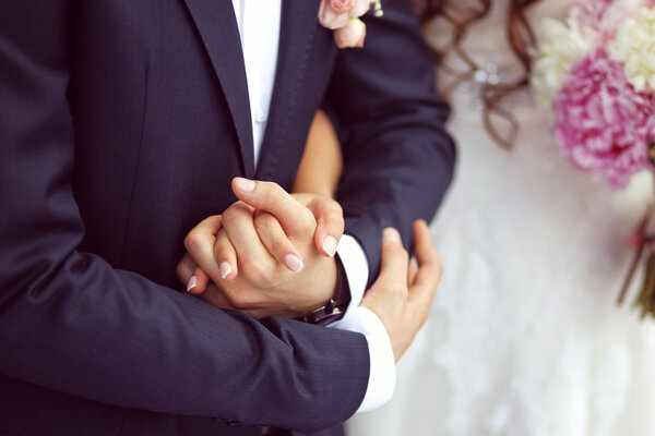 Beautiful bride and groom with bouquet on wedding day