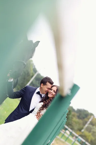 Bride and groom having fun horse riding — Stock Photo, Image