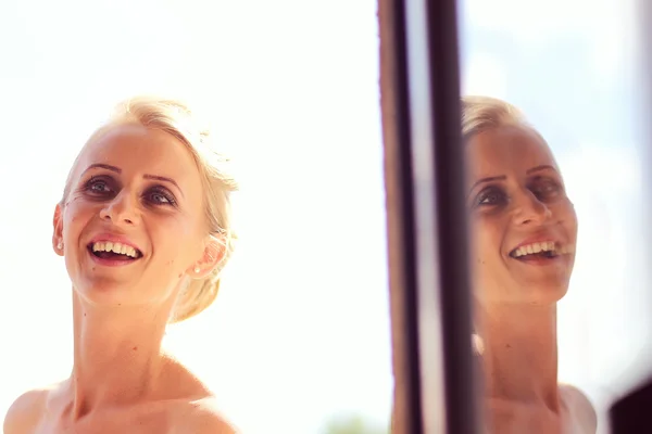 Joyful bride getting professional make up before wedding — Stock Photo, Image