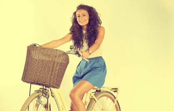 Jonge en mooie vrouwen op een fiets in de studio — Stockfoto