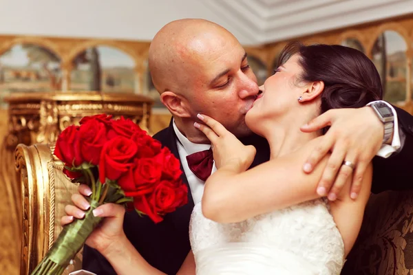 Beautiful bride and groom embracing and kissing on wedding day — Stock Photo, Image