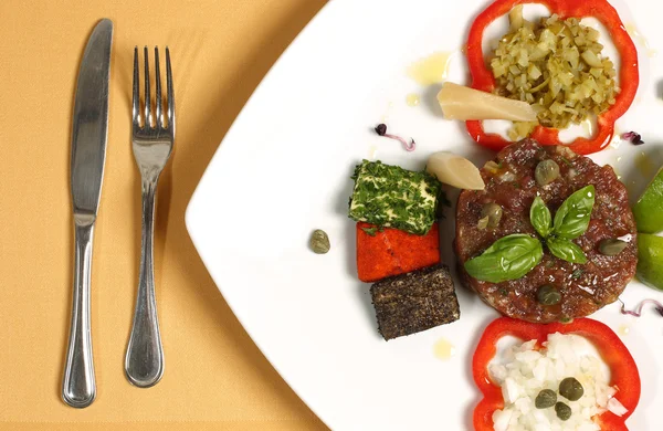 Νόστιμα γκουρμέ φαγητό στο εστιατόριο στο πιάτο με το πηρούνι και μαχαίρι — Φωτογραφία Αρχείου
