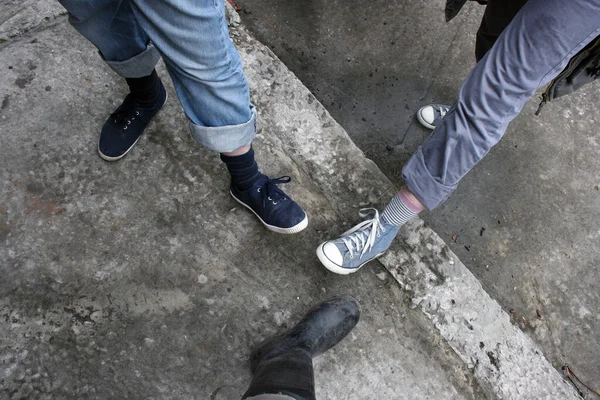 Top View Three Different Pairs Shoes People Stand Concrete Pavement — Stock Photo, Image