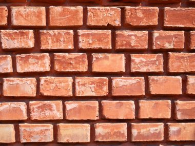 Kırmızı tuğla bir duvar parçası. Dar tuğla işi. Parlak arkaplan.