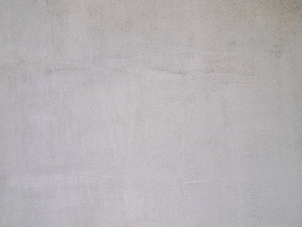 Gri taneli beton arka plan. Yüzey alçı ve boyayla kaplı..