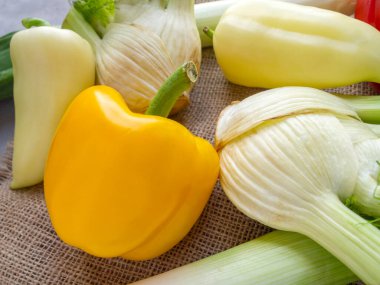 Küçük metal bir kaşıkla beyaz bir kasede peynir sosu (coulis de parmesan) yan görüntüsü. Parmesan, krema ve safran içerir.. 