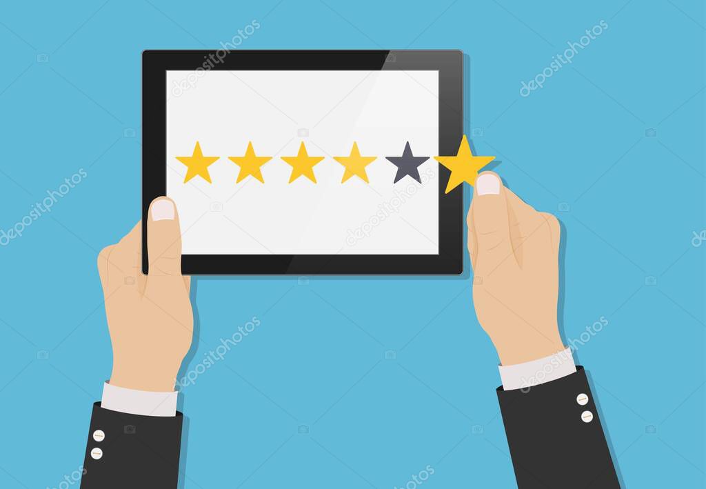 Hand holding tablet with yellow rank stars on screen. Concept of feedback. Template design of voting, rating, customer reviews and evaluation. Vector illustration
