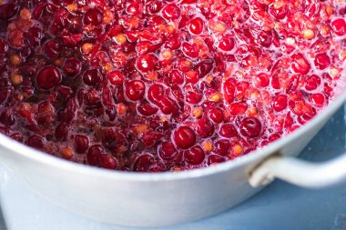 Vişne likörü hazırlarken bir tencerede kırmızı kirazlar. Koruma, kiraz reçeli, komposto