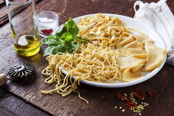 Homemade Pasta and Olive Oil on wooden table — Stock Photo, Image
