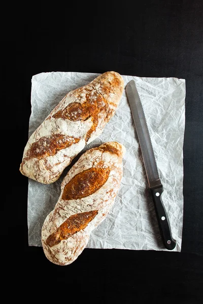 Rye bread and a knife for cutting bread — Stock Photo, Image