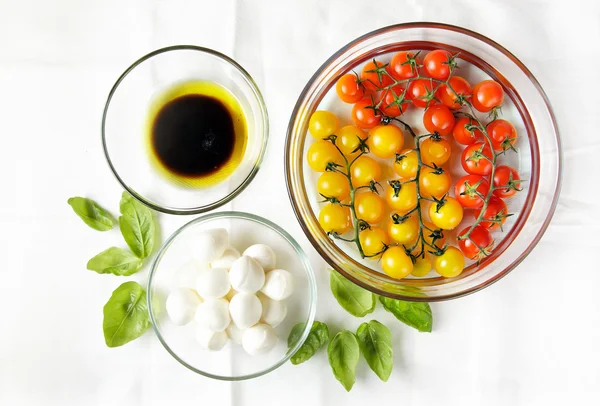 Ingredientes en blanco. Tomates cherry: rojo y amarillo. Pequeño mo —  Fotos de Stock