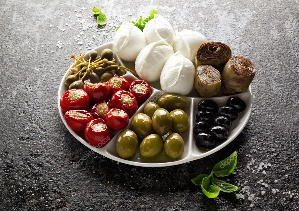 Appetizer tray of green olives, black olives, capers, buffalo mo Stock