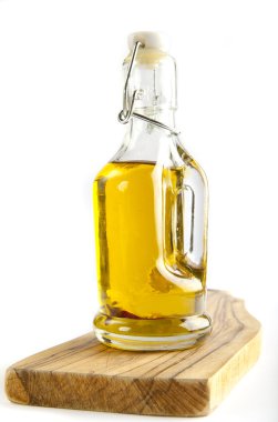 bir şişe zeytinyağı ahşap tahta üzerinde. Beyaz