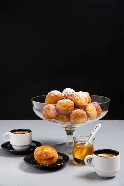 Donuts in a glass vase , coffee and honey — Stock Photo, Image