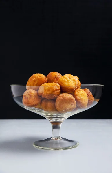 Donuts in a glass vase , coffee and honey — Stock Photo, Image