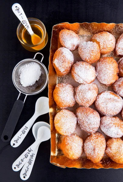 Donuts in a glass vase, powdered sugar and honey — Stock Photo, Image
