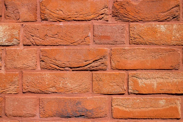 Decorative orange painted brick wall. Repair of home interiors and building facades. Decorative brick wall background with copy space.